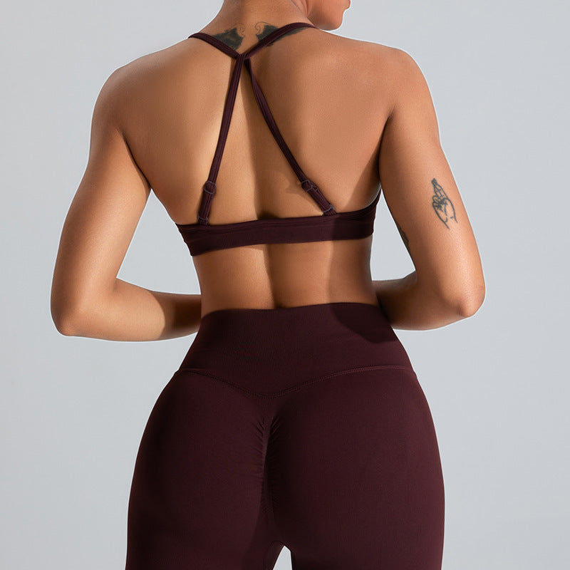 Barbie Pink seamless strappy yoga bra by Alabaster, featuring breathable fabric and a stylish design.