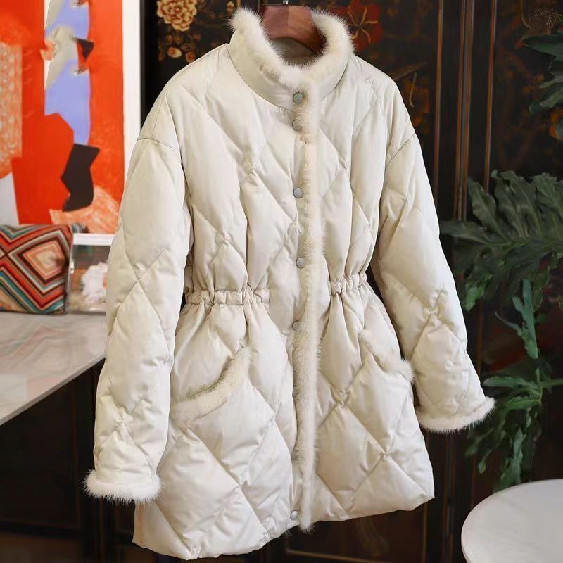 Beige women's quilted winter coat with faux fur trim and cinch waist by Alabaster