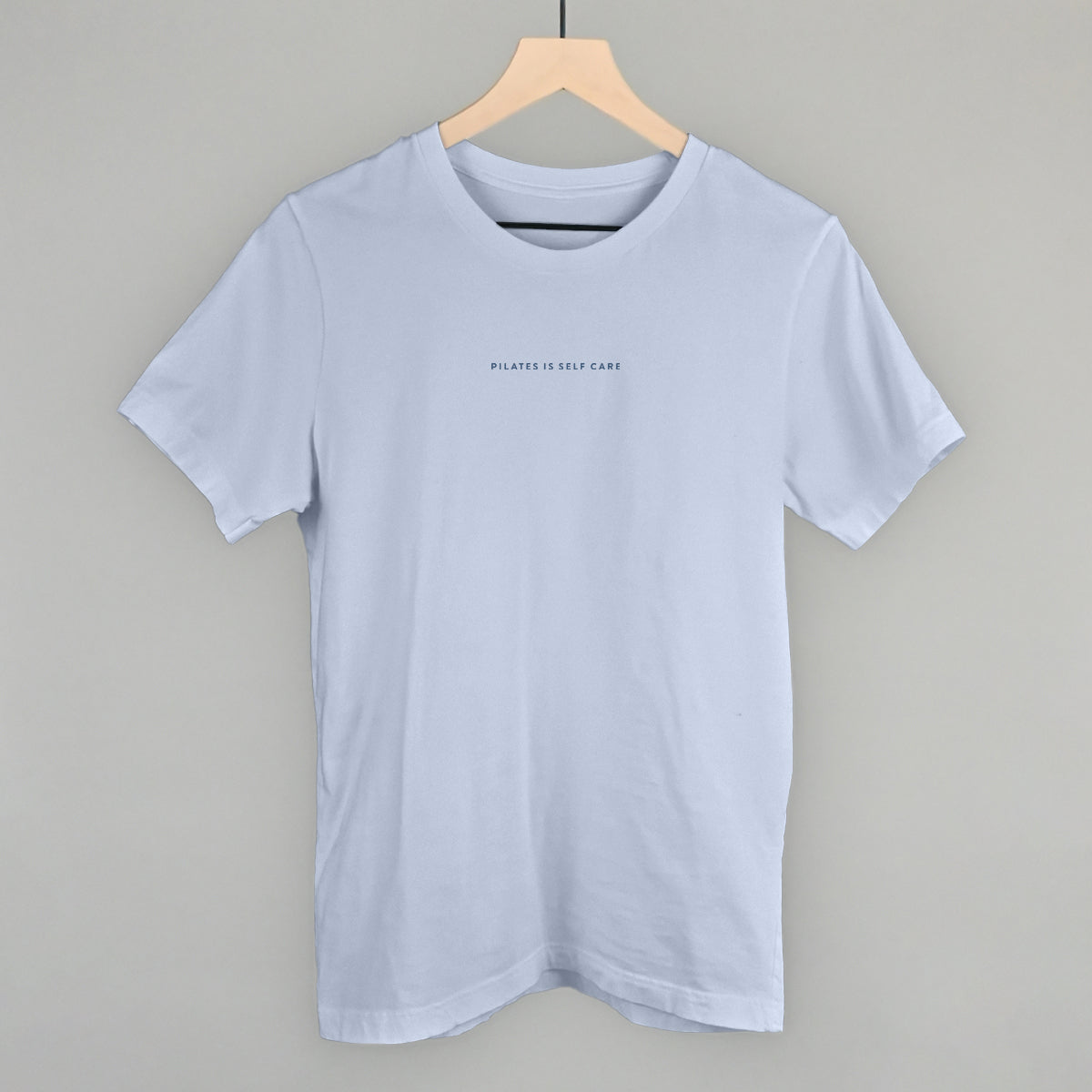 Light blue cotton tee from Ivy + Cloth's Pilates Is Self Care Collection, perfect for cozy athleisure wear.