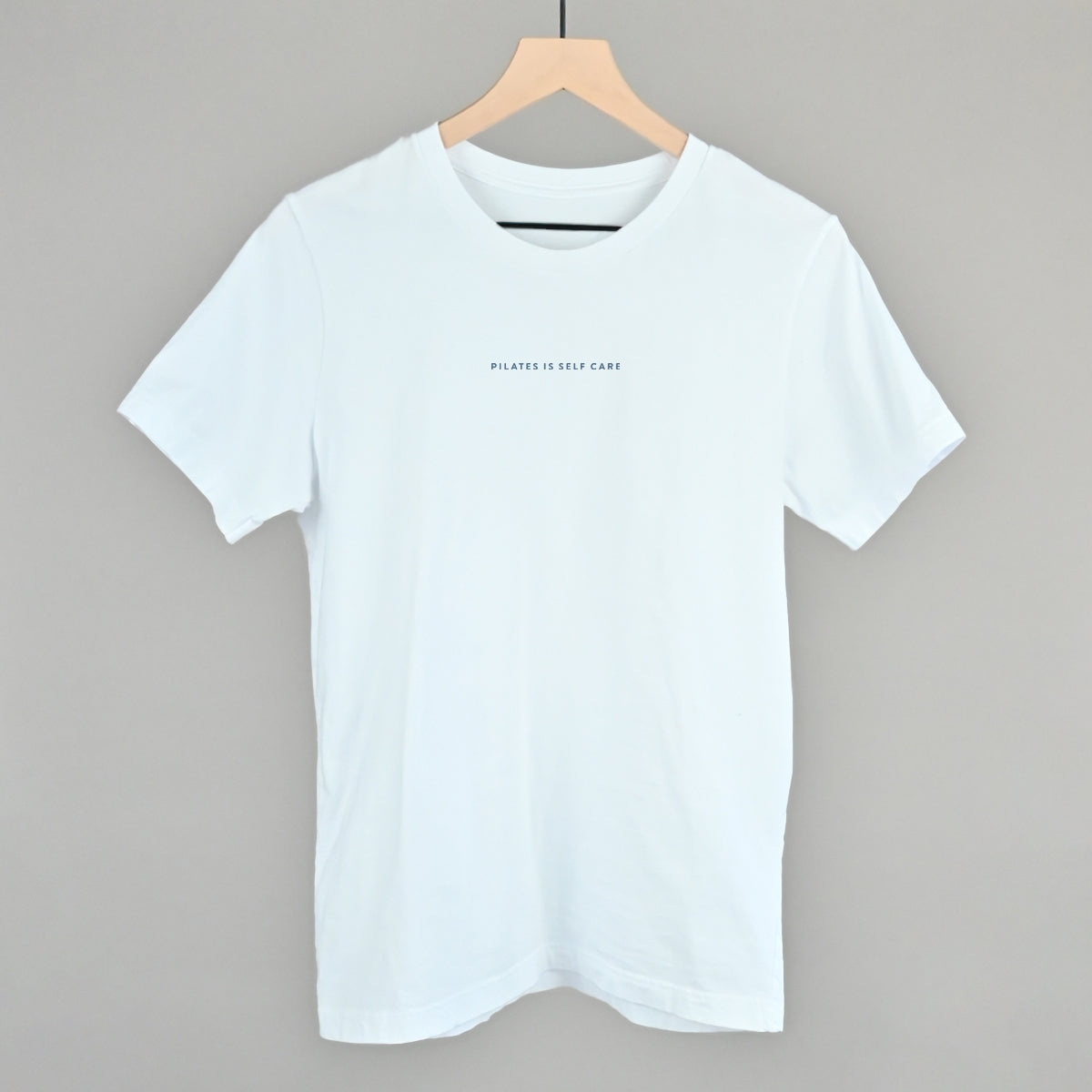 Light blue cotton tee from Ivy + Cloth, part of the Pilates Is Self Care Collection, available in sizes S, M, and L.