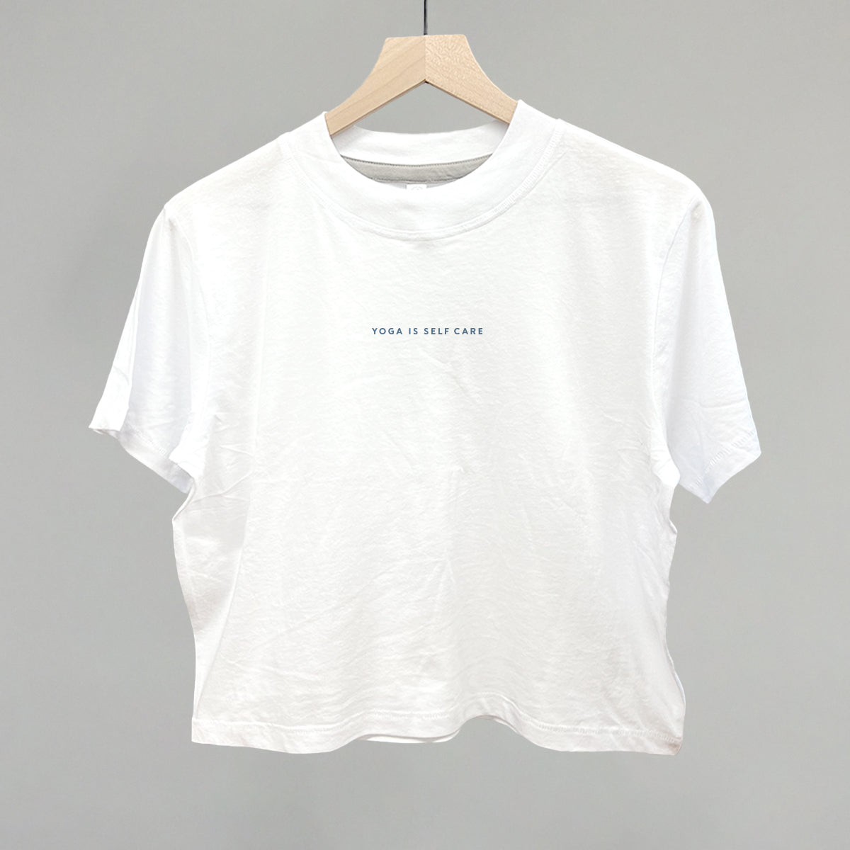 Oatmeal sweatshirt with 'Yoga Is Self Care' text by Ivy + Cloth, perfect for comfort and wellness.