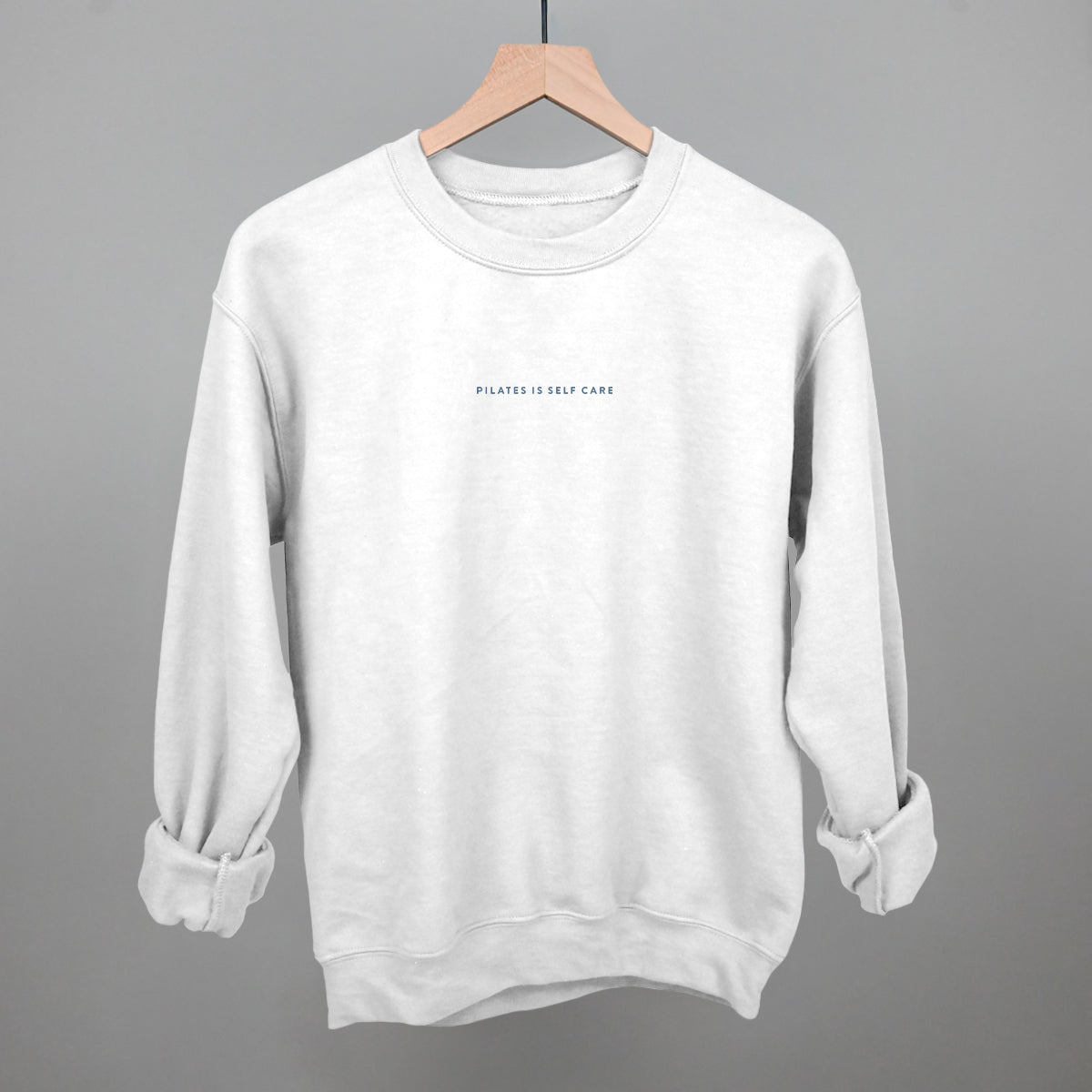 Light blue cotton tee from Ivy + Cloth, part of the Pilates Is Self Care Collection, available in sizes S, M, and L.