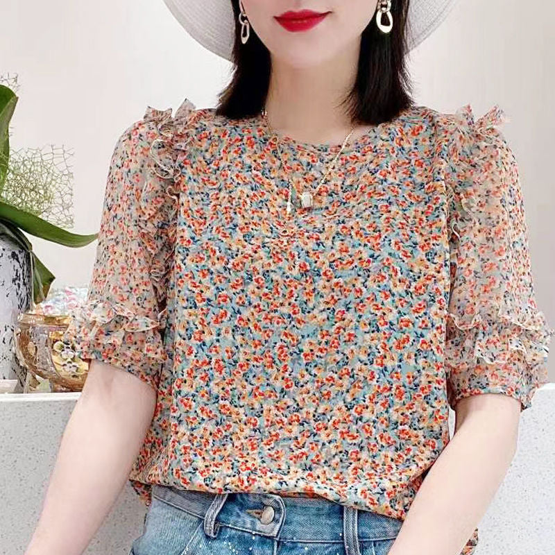 Light blue floral chiffon blouse with ruffle sleeves by Alabaster, featuring a lightweight and breathable design.