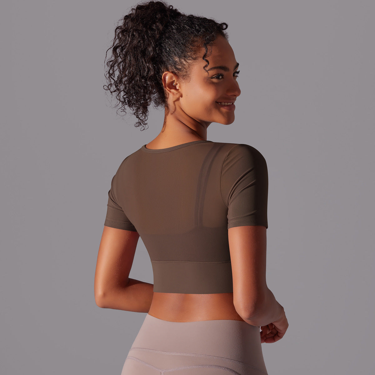 Black mesh double layer cutout sports bra by Alabaster, featuring breathable fabric and body-hugging fit.