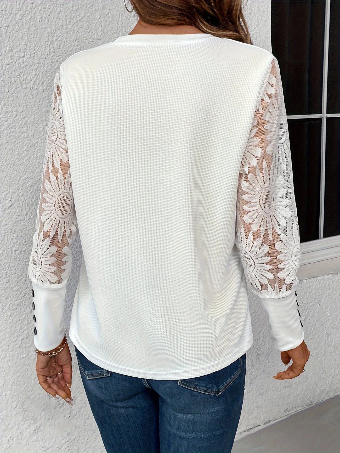White lace floral long sleeve blouse with buttoned cuffs by Alabaster, featuring a clean silhouette and contrast cuffs.