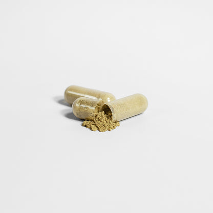 Green Moringa Pure Organic Leaf Capsules in a clear bottle by mywellness.health, allergen-free and natural supplement.