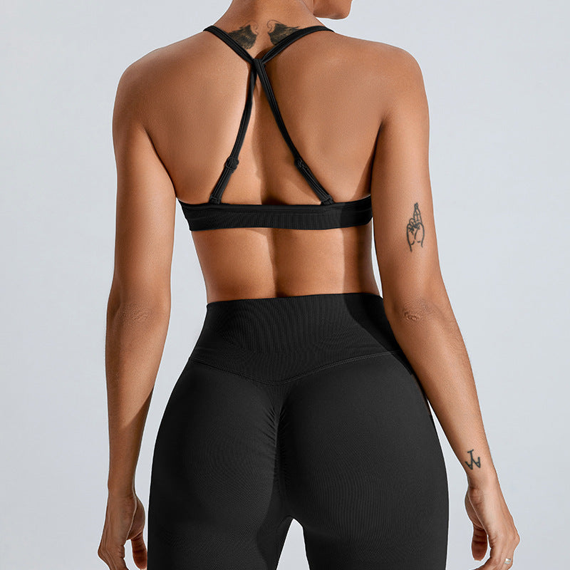 Barbie Pink seamless strappy yoga bra by Alabaster, featuring breathable fabric and a stylish design.