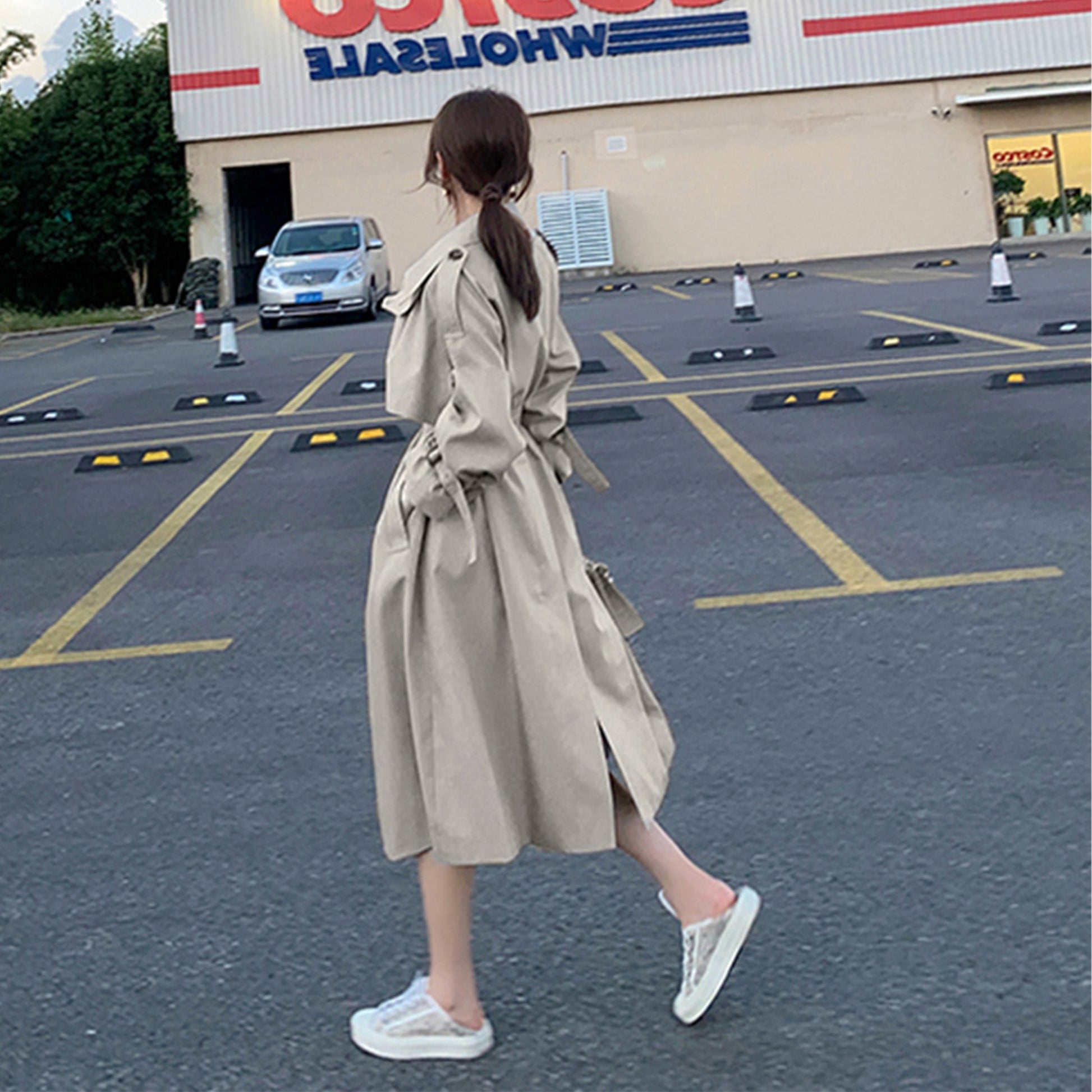 Gray green mid-length oversized trench coat by Alabaster with double-breasted front and adjustable cuffs