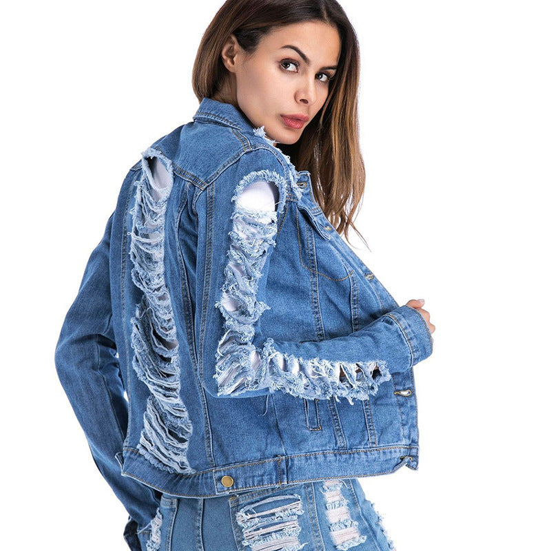 Distressed blue denim cropped fringe jacket by Alabaster, featuring shredded cotton and a bold, edgy style.