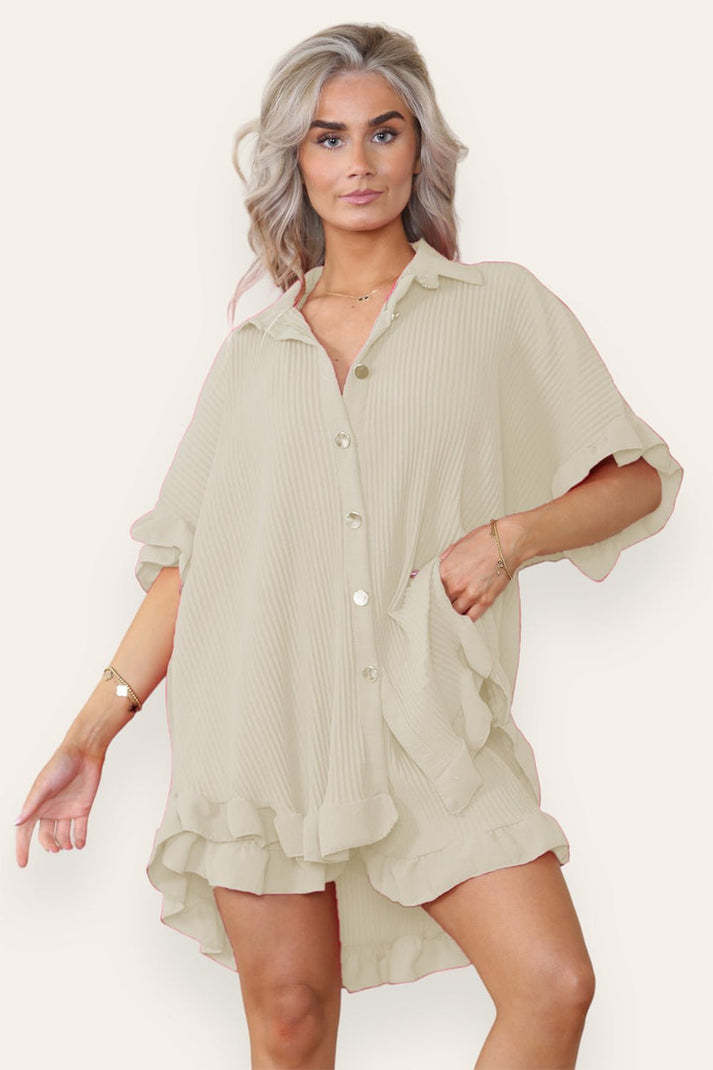 Turquoise women's ruffle co-ord set featuring an oversized button shirt and shorts with gold buttons by Alabaster