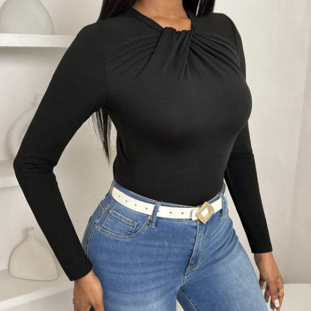 Black pleated collar slim fit top by Alabaster, featuring a curve-hugging design, suitable for elegant occasions.
