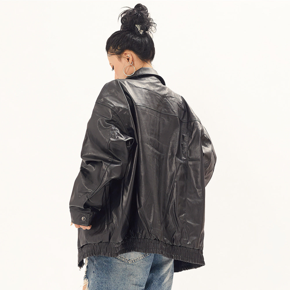 Black oversized punk moto PU leather jacket by Alabaster with button closure and biker style