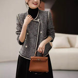 Black and white tweed double-breasted short coat by Alabaster, perfect for autumn layering.