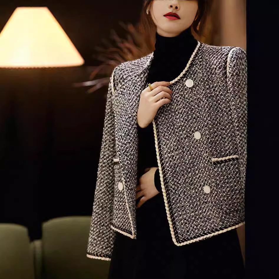 Black and white tweed double-breasted short coat by Alabaster, perfect for autumn layering.