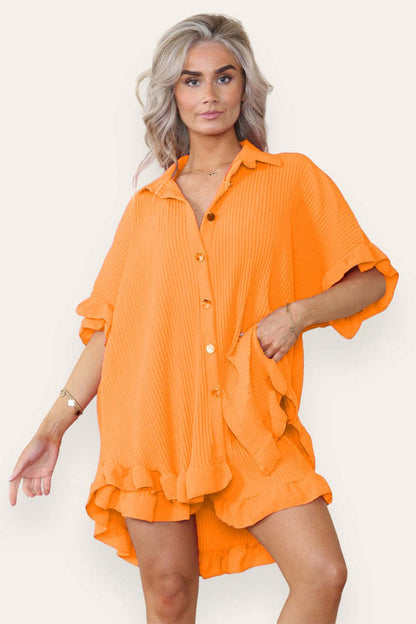 Turquoise women's ruffle co-ord set featuring an oversized button shirt and shorts by Alabaster with gold buttons.