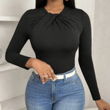 Black pleated collar slim fit top by Alabaster, featuring a curve-hugging design, perfect for elegant occasions.