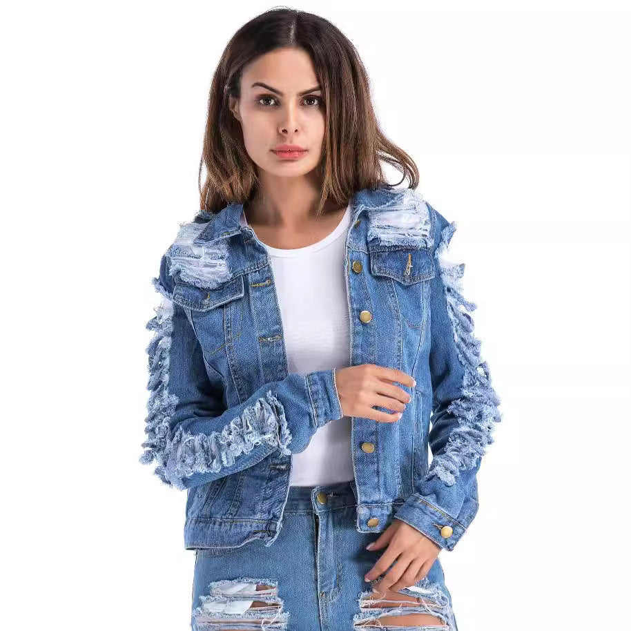 Distressed blue denim fringe jacket, cropped style, shredded cotton, by Alabaster, showcasing bold personality.