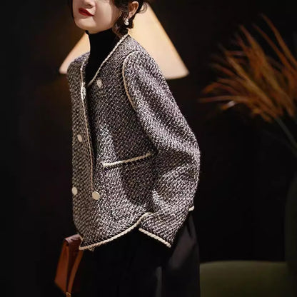Black and white tweed double-breasted short coat by Alabaster, perfect for autumn layering.