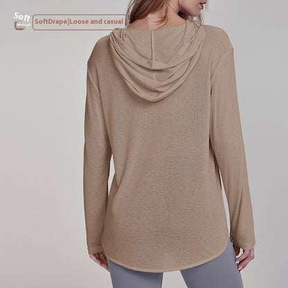 Kaki brown hooded long sleeve yoga top with curved hem and button-front by Alabaster, made for breathable comfort.