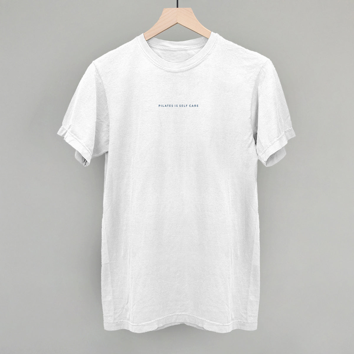 Light blue cotton tee from Ivy + Cloth, part of the Pilates Is Self Care Collection, available in sizes S, M, and L.