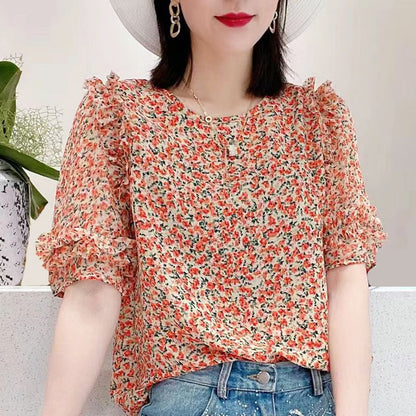 Light blue floral chiffon blouse with ruffle sleeves by Alabaster, featuring a lightweight and breathable design.