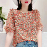 Light blue floral chiffon blouse with ruffle sleeves by Alabaster, featuring a lightweight and breathable design.
