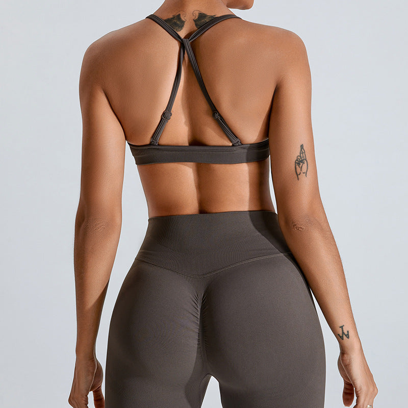 Barbie Pink seamless strappy yoga bra by Alabaster, featuring breathable fabric and a stylish design.