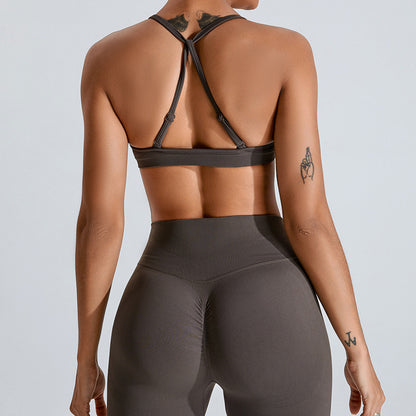 Barbie Pink seamless strappy yoga bra by Alabaster, featuring breathable fabric and a stylish design.