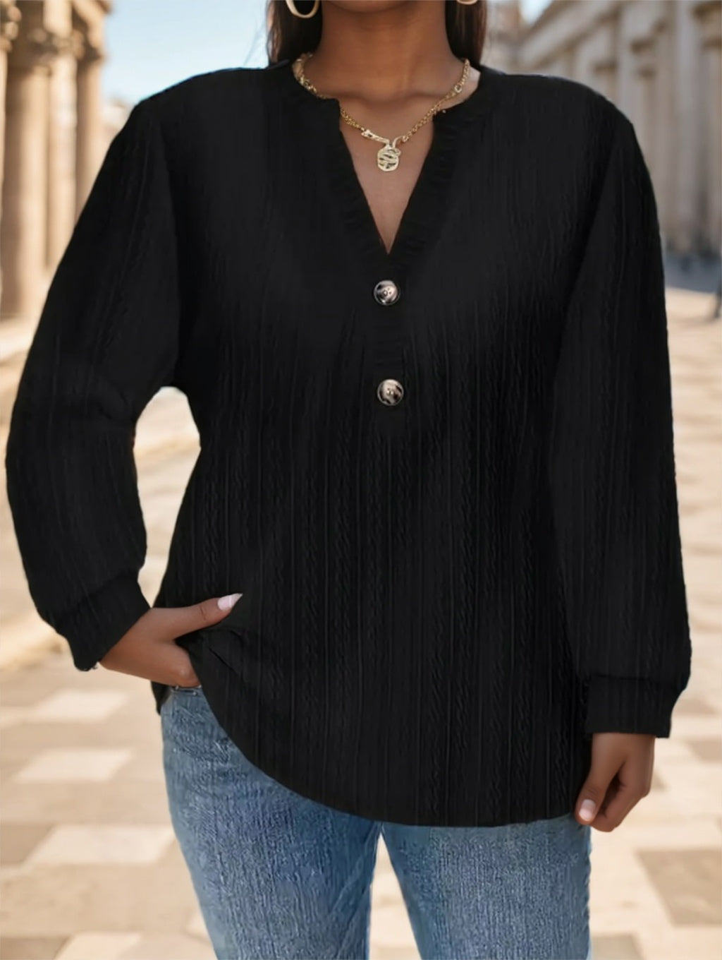 Black long sleeve shirt with button detail by Alabaster, available in sizes S, M, and L