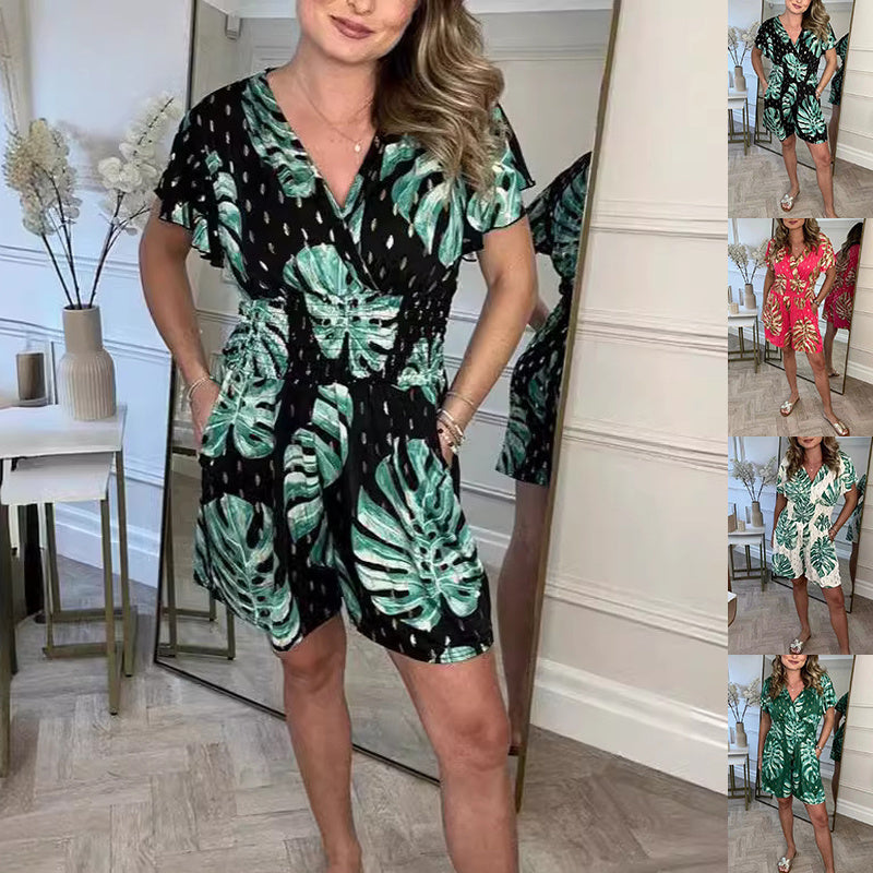 Black lightweight tropical leaf print jumpsuit with V-neck, perfect for summer beach wear by Alabaster.