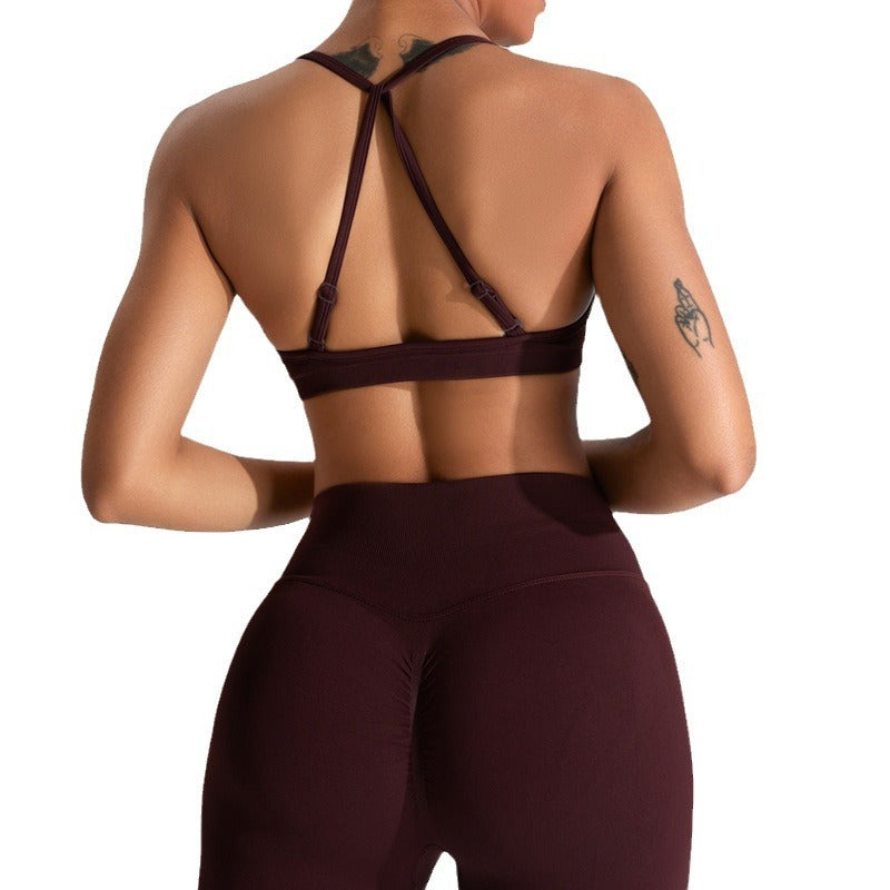 Barbie Pink seamless strappy yoga bra by Alabaster, designed for breathability and comfort in activewear.