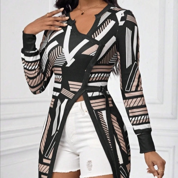 Black geometric print tee with cinched waist and dramatic side slit, made of breathable polyester by Alabaster
