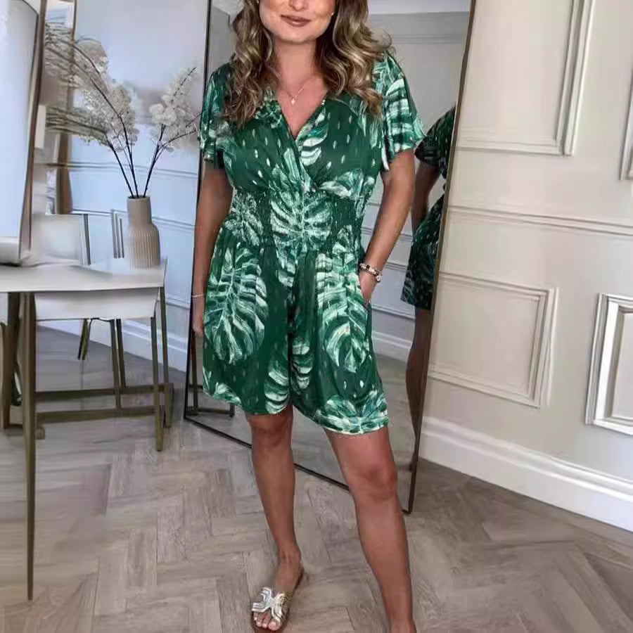 Black lightweight tropical leaf print jumpsuit with V-neck, perfect for summer beach wear and casual outings.