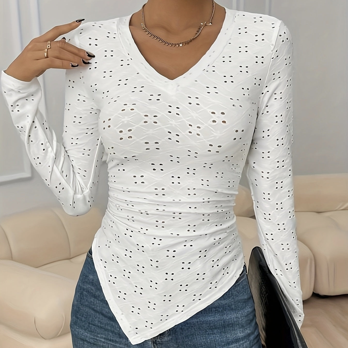 White polyester long sleeve top with eyelet cutouts and V-neck by Alabaster