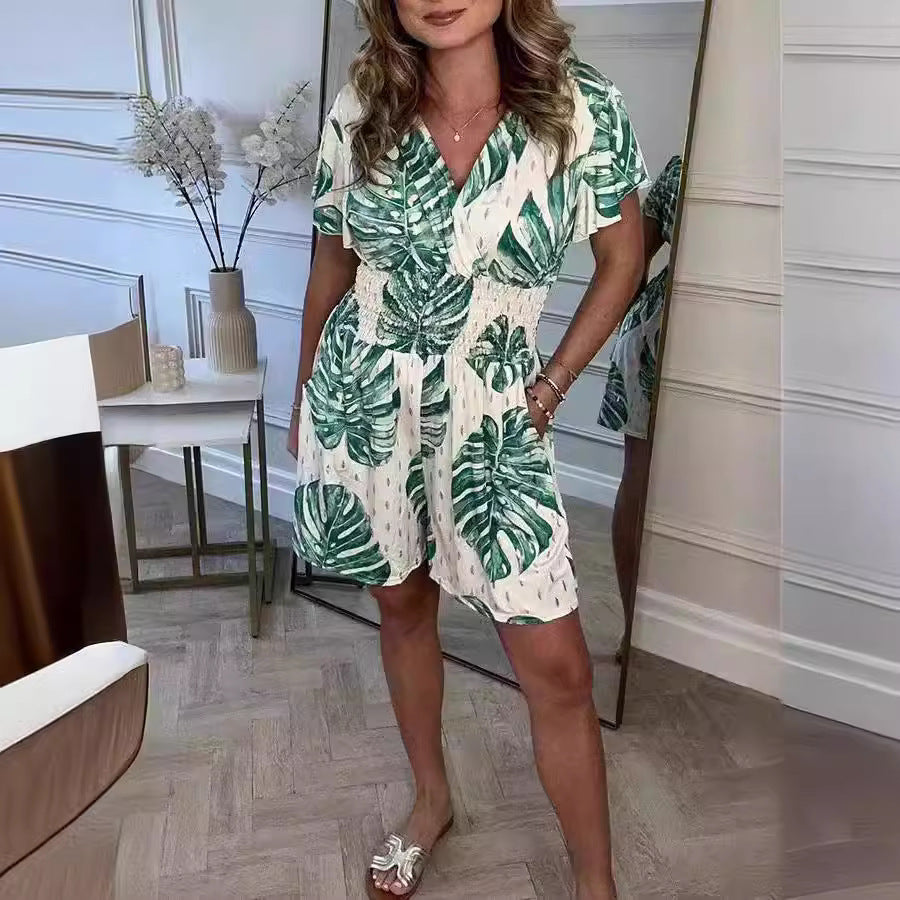 Black lightweight tropical leaf print jumpsuit with V-neck, perfect for summer casual wear by Alabaster