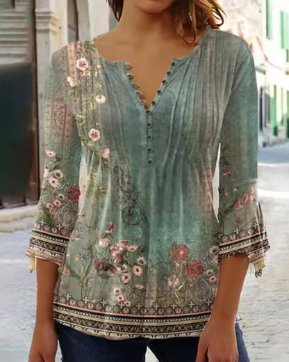 White floral V-neck pleated blouse with 3/4 sleeves and button front by Alabaster